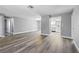 Spacious living room with wood-look floors and ample natural light flowing into an open floor plan at 14136 Payne St, Spring Hill, FL 34609