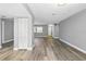 Bright open-concept living room with modern gray walls and hardwood flooring at 14136 Payne St, Spring Hill, FL 34609