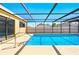 The screen enclosed pool features bright blue water and convenient access to the home at 14136 Payne St, Spring Hill, FL 34609