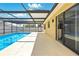 Pool and patio featuring a screen enclosure and sliding glass door at 14136 Payne St, Spring Hill, FL 34609