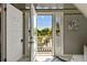 Bright balcony offers serene views of lush landscape with beautiful skies visible from open doors at 1500 Elmwood St, Clearwater, FL 33755