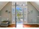 Balcony view from bright room with hardwood floors and neutral colors showcasing outdoor scenery through open doors at 1500 Elmwood St, Clearwater, FL 33755
