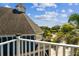 Beautiful blue home showcasing rooftop view and blue skies from balcony with railing and view of neighboring landscape at 1500 Elmwood St, Clearwater, FL 33755