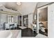 Spacious bathroom features vanity with mirror, patterned wallpaper, marble tub and convenient entry to the toilet at 1500 Elmwood St, Clearwater, FL 33755