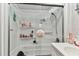 Bathroom shower with built-in shelves and sleek glass sliding doors, offering a modern look at 1500 Elmwood St, Clearwater, FL 33755
