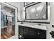 Elegant black and white bathroom featuring marble countertops, large mirror, and stylish fixtures for a sophisticated design at 1500 Elmwood St, Clearwater, FL 33755