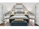 Bedroom with hardwood floors and white accents, featuring side tables, lamps, and a neutral color palette at 1500 Elmwood St, Clearwater, FL 33755