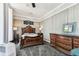 Bedroom with an ornate wooden bed frame, side tables, and a matching dresser showcasing a luxurious aesthetic at 1500 Elmwood St, Clearwater, FL 33755