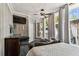 Bedroom offering views of a backyard, featuring a luxurious bed, and unique ceiling design at 1500 Elmwood St, Clearwater, FL 33755