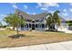 Charming blue Victorian home with a white picket fence, lush landscaping, and two-car garage at 1500 Elmwood St, Clearwater, FL 33755