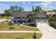 Stately two-story home boasts a wrap-around porch, lush landscaping, and a spacious driveway at 1500 Elmwood St, Clearwater, FL 33755