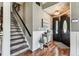 Inviting foyer with beautiful hardwood floors, staircase, and stylish decor at 1500 Elmwood St, Clearwater, FL 33755