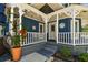 Inviting front porch with a swing, lovely flowers, and classic architectural details at 1500 Elmwood St, Clearwater, FL 33755