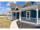 Charming front porch with white railings leading to a blue Victorian-style home at 1500 Elmwood St, Clearwater, FL 33755