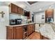 Kitchenette with granite countertops, wood cabinets, and adjacent casual seating. Perfect for entertaining guests at 1500 Elmwood St, Clearwater, FL 33755