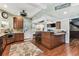 Bright eat-in kitchen with an island, bar stool seating, stainless appliances and direct access to the back yard at 1500 Elmwood St, Clearwater, FL 33755