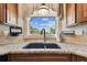 A close-up view of a kitchen sink with granite countertops and a window view of the outdoors at 1500 Elmwood St, Clearwater, FL 33755