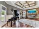 Stylish living room with hardwood floors, fireplace, piano and coffered ceiling at 1500 Elmwood St, Clearwater, FL 33755
