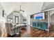 This open floorplan living room has wood-look floors, stylish furniture and a flat screen television at 1500 Elmwood St, Clearwater, FL 33755