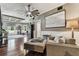 Elegant living room featuring a large ceiling fan, dark wood floors, and an oversized sheet music art piece at 1500 Elmwood St, Clearwater, FL 33755