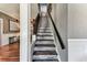 An elegant staircase with wood and carpeted steps ascends to the upper level of the home at 1500 Elmwood St, Clearwater, FL 33755