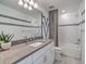 Modern bathroom featuring gray accents, an undermount sink, gray countertops, and a tub-shower combination at 17130 Moonflower Dr, Venice, FL 34293