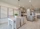 Bright kitchen features gray cabinetry, stainless appliances, and a dining area with a modern chandelier at 17130 Moonflower Dr, Venice, FL 34293