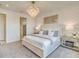 Stylish main bedroom featuring an accent wall, chandelier, and modern furnishings at 17130 Moonflower Dr, Venice, FL 34293