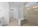Modern bathroom with glass shower, built-in bench and neutral tile at 17200 Luminous Ave, Venice, FL 34293