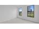 Bright bedroom featuring two windows, neutral carpet and white walls at 17200 Luminous Ave, Venice, FL 34293
