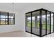 Dining area with a modern chandelier and sliding glass doors opening to the outdoor space at 17200 Luminous Ave, Venice, FL 34293