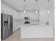 Bright kitchen featuring stainless steel appliances, white cabinets, quartz countertops, and a large island at 17200 Luminous Ave, Venice, FL 34293