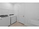 Well-lit laundry room with modern washer, dryer, sink, tile floors and wire shelving at 17200 Luminous Ave, Venice, FL 34293