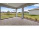 Screened patio overlooking a grassy yard with neighborhood views on a clear day at 17200 Luminous Ave, Venice, FL 34293