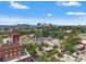 Aerial view with the skyline, clock tower, parking lot, and quaint neighborhood creating a vibrant urban landscape at 1816 E 15Th Ave, Tampa, FL 33605