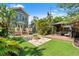 Spacious backyard with a stone fire pit, outdoor seating, and lush landscaping, ideal for entertaining at 1816 E 15Th Ave, Tampa, FL 33605