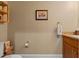 Cozy half bathroom with warm beige walls, wood shelf, and whale artwork at 1816 E 15Th Ave, Tampa, FL 33605