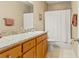 Bathroom features a granite vanity countertop and shower with curtain at 1816 E 15Th Ave, Tampa, FL 33605