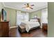 Bedroom features hardwood floors, a ceiling fan and a large window at 1816 E 15Th Ave, Tampa, FL 33605