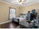 This charming bedroom features a ceiling fan, hardwood floors and natural light at 1816 E 15Th Ave, Tampa, FL 33605
