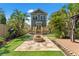 Charming home exterior with a well-manicured lawn, a stone fire pit, and lush tropical landscaping at 1816 E 15Th Ave, Tampa, FL 33605