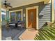 Cozy front porch with seating, a ceiling fan, and a beautifully crafted wooden front door at 1816 E 15Th Ave, Tampa, FL 33605