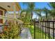 Well-maintained front yard with lush greenery, flowers, and a black metal fence at 1816 E 15Th Ave, Tampa, FL 33605