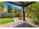 Relaxing gazebo area with a view of the stone fire pit and lush backyard landscaping at 1816 E 15Th Ave, Tampa, FL 33605