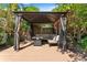Cozy gazebo with comfortable seating, providing a shaded retreat within the beautifully landscaped backyard at 1816 E 15Th Ave, Tampa, FL 33605