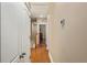 Hallway with thermostat, wood floors, and doors to bedrooms and closets at 1816 E 15Th Ave, Tampa, FL 33605