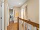 Hallway with hardwood floors and railing to the staircase at 1816 E 15Th Ave, Tampa, FL 33605