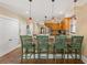 Open kitchen with bar area, stainless steel appliances, and decorative pendant lighting at 1816 E 15Th Ave, Tampa, FL 33605