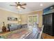 Warm room with a dining table, chairs, love seat, and a large media cabinet at 1816 E 15Th Ave, Tampa, FL 33605