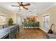 An open-concept space with a kitchen area, dining table, and chairs with an adjacent living area at 1816 E 15Th Ave, Tampa, FL 33605